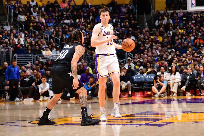 LOS ANGELES, CA - MARCH 19: Austin Reaves #15 of the Los Angeles Lakers dribbles the ball during the game.