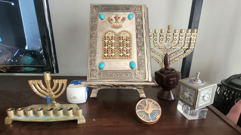 Sara Katz displays various heirlooms such as hand-carved dreidels, a family torah and ornate menorahs. - Courtesy Sara Katz