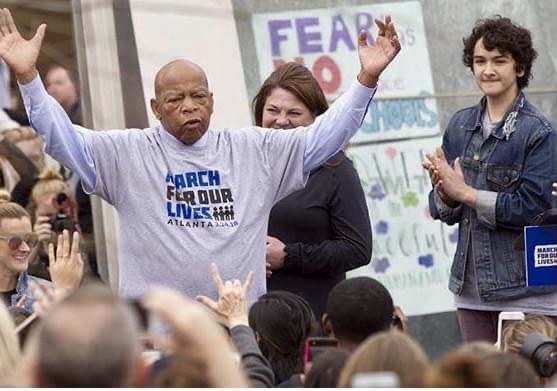Atlanta Board of Education candidate Royce Carter Mann, right, worked as the legislative director for March for Our Lives Georgia and introduced the late Sen. John Lewis at the 2018 event. (Courtesy of Royce Carter Mann)