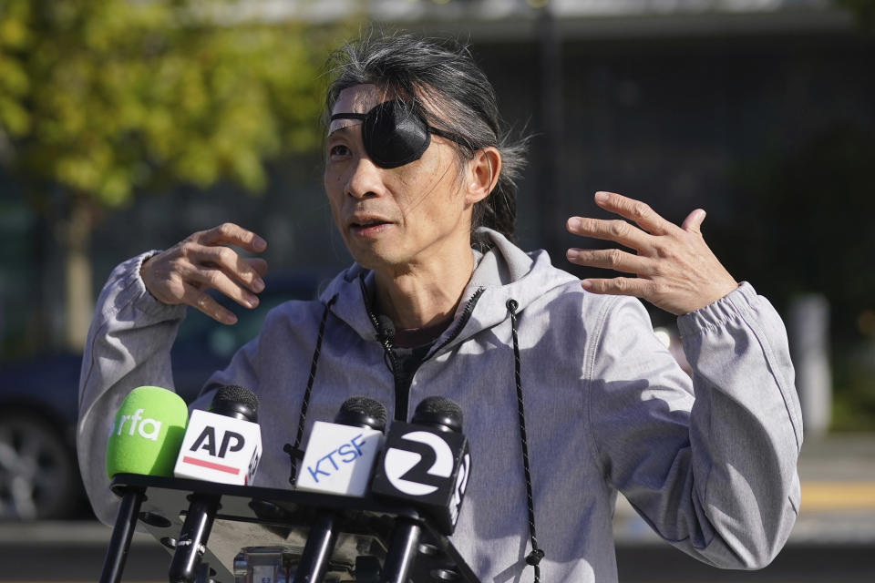 Kaiyu Zhang speaks with reporters about being assulated by a group of young men wearing red headbands or red bands on their arms, during a news conference in San Francisco, Wednesday, Nov. 29, 2023. A man protesting the Chinese government during the recent Asia-Pacific economic summit in San Francisco shared details about an attack by China supporters that he says left him unconscious, and he urged local police to take action against the perpetrators. Zhang, who moved from Shanghai to Los Angeles in March, was assaulted on Nov. 17, 2023. (AP Photo/Jeff Chiu)