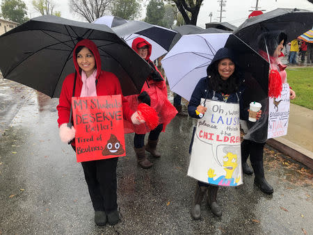 Striking Los Angeles teachers carry homemade signs at a rally at a school district office in Gardena just south of downtown Los Angeles, California, U.S. January 16, 2018. REUTERS/Dan Whitcomb