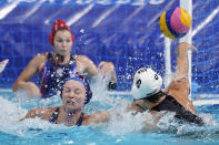 United States' Margaret Steffens (6) gets her shot away as she is defended by Evgeniya Ivanova, lower left, of the Russian Olympic Committee, during a preliminary round women's water polo match at the 2020 Summer Olympics, Friday, July 30, 2021, in Tokyo, Japan. (AP Photo/Mark Humphrey)