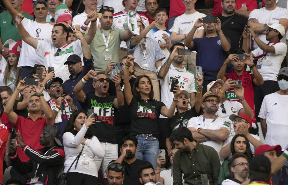 Iranian supporters react during the Iran's national anthem ahead the World Cup group B soccer match between England and Iran at the Khalifa International Stadium in in Doha, Qatar, Monday, Nov. 21, 2022. (AP Photo/Alessandra Tarantino)