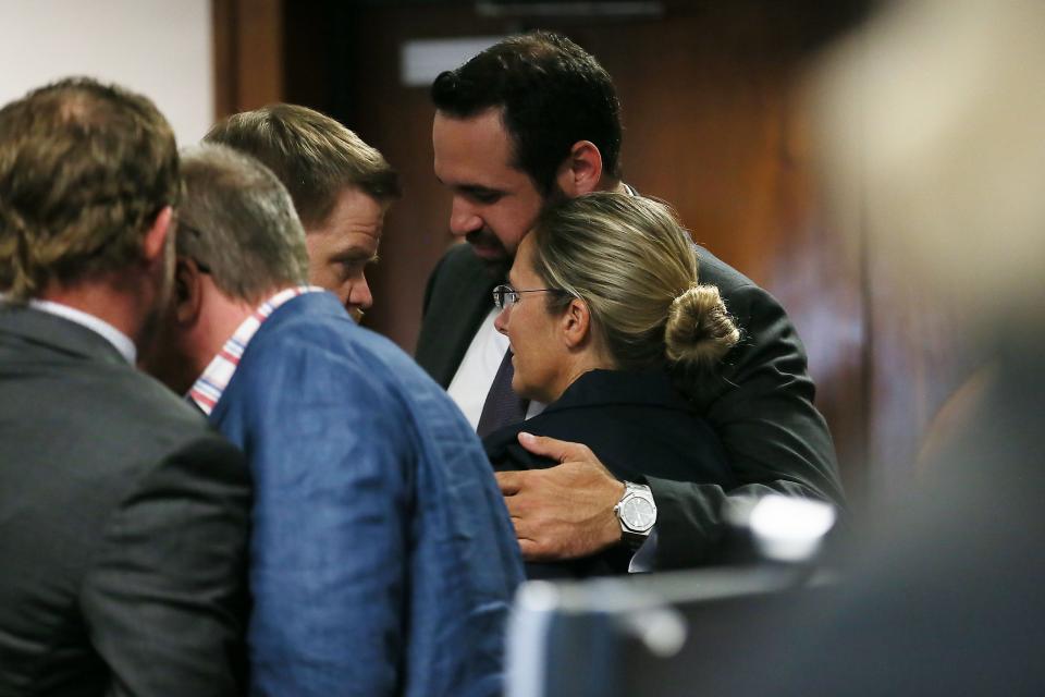 Bill Ogden, one of the lawyers for Sandy Hook parents Scarlett Lewis and Neil Heslin, gives Lewis a hug after the trial against Alex Jones concluded Friday.