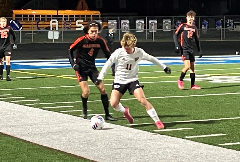 Fairfield Union junior Will Worthington battles a Marietta defender for the ball during the Falcons' 2-1 Division II regional semifinal win over the Tigers on Wednesday night at Chillicothe's Herrnstein Field.