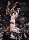 Toronto Raptors forward Precious Achiuwa (5) drives as Memphis Grizzlies forward Brandon Clarke (15) defends during the first half of an NBA basketball game Tuesday, Nov. 30, 2021, in Toronto. (Nathan Denette/The Canadian Press via AP)