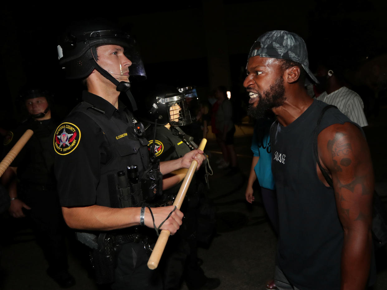 A man confronts police outside the Kenosha Police Department