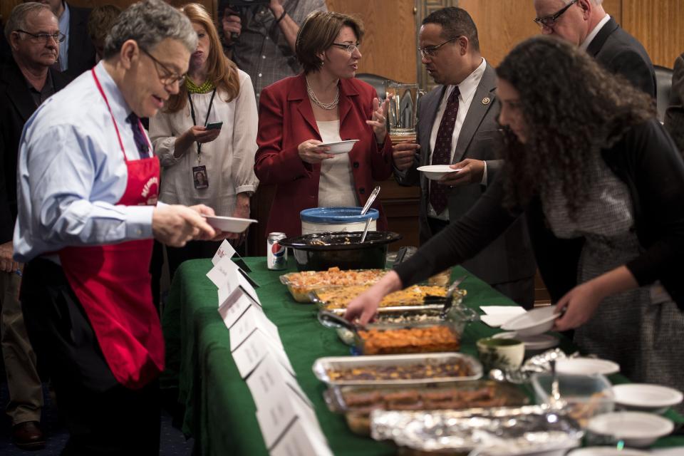 Members of the Minnesota delegation taste each other's entries during the Minnesota Congressional Delegation Hotdish Competition on Capitol Hill on April 22, 2015. Hotdish is a meal similar to a casserole.