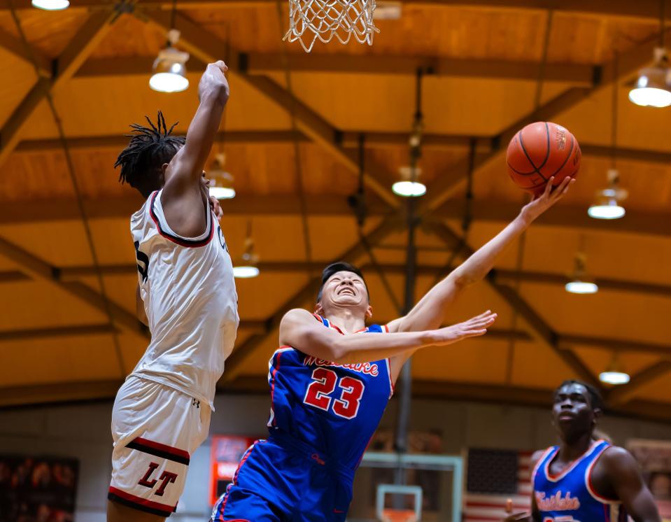 Westlake guard Donovan Lee sends a shot to the basket as Lake Travis forward Jayden Thomas defends during the first period. The Chaparrals' victory pulled them to within one game of district-leading Lake Travis and Johnson with seven games to go.