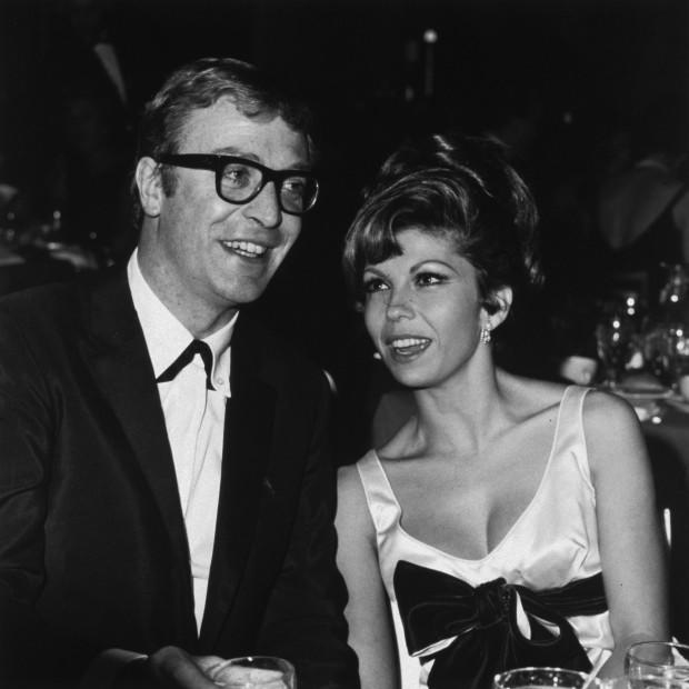 December 1965: British actor Michael Caine sits next to American singer and actor Nancy Sinatra at the premiere party for Martin Ritt's film, 'The Spy Who Came in from the Cold', Hollywood, California.<p><a href="https://www.gettyimages.com/detail/3232346" rel="nofollow noopener" target="_blank" data-ylk="slk:Max B. Miller/Getty Images;elm:context_link;itc:0;sec:content-canvas" class="link ">Max B. Miller/Getty Images</a></p>