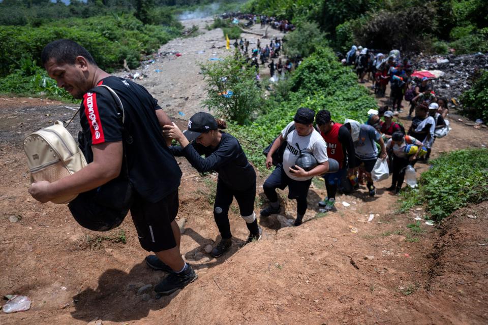 Migrants walk by the jungle near Bajo Chiquito village, the first border control of the Darién Province in Panama, on September 22, 2023.