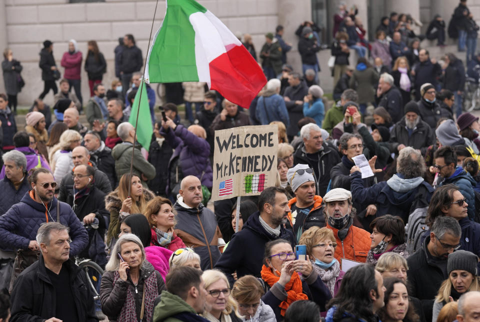 People gather for a protest against the COVID-19 vaccination green pass, attended by Robert F. Kennedy Jr., son of Robert Kennedy, in Milan, Italy, Saturday, Nov. 13, 2021. (AP Photo/Antonio Calanni)