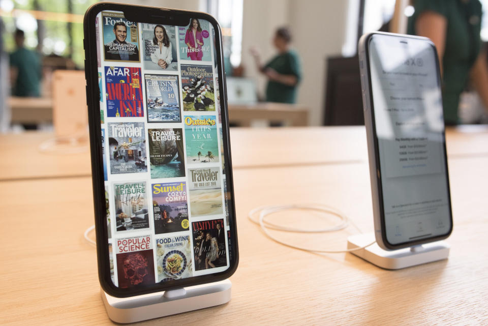 iPhones are on display as Apple opens their new store, Apple Carnegie Library, in Washington, Saturday, May 11, 2019. (AP Photo/Cliff Owen)