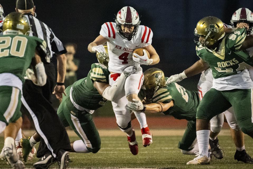 New Palestine High School senior Grayson Thomas (4) runs the ball out of the back field during the second half of an IHSAA varsity football game against Westfield High School, Friday, Aug. 18, 2023, at Westfield High School. Westfield won 34-14.