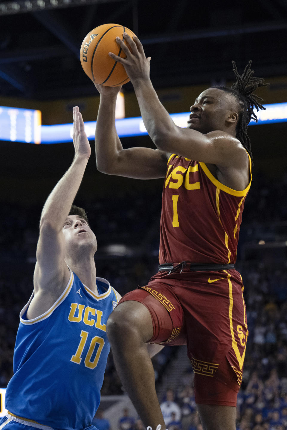 Southern California guard Isaiah Collier (1) goes to the basket next to UCLA guard Lazar Stefanovic (10) during the first half of an NCAA college basketball game Saturday, Feb. 24, 2024 in Los Angeles. (AP Photo/Kyusung Gong)