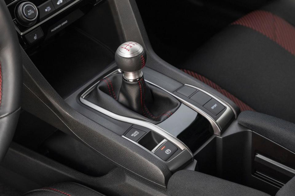 <p>A six-speed manual gearbox is still the only way you can get the Civic Si. To improve acceleration, Honda added a new shorter final-drive ratio (from 4.105:1 to 4.35:1), and to enhance sound in the cabin, there's now Active Sound Control, which amplifies the natural engine sound and pumps it through the speakers. We're usually not a fan of pumping fake sound into the cabin, but Honda does a good job of making it louder but not going overboard.</p><p>The new shorter final-drive ratio is meant to aid in acceleration in every gear, but the trade-off is a 2-mpg loss across the board, which results in a 26/36 city/highway fuel-economy rating. #SavetheManuals</p>