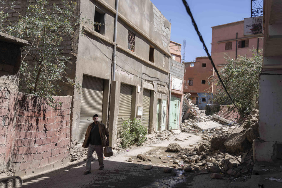 A man inspects the damage caused by the earthquake, in the town of Amizmiz, near Marrakech, Morocco, Sunday, Sept. 10, 2023. Towns and villages throughout Morocco's Atlas Mountains are mourning the dead and seeking aid after a record earthquake wreaked destruction throughout the region last week. (AP Photo/Mosa'ab Elshamy)