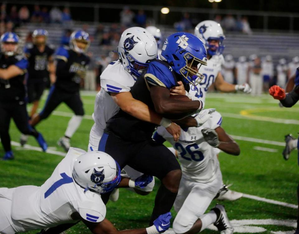 Indian Land’s Demarcus Peake is brought down by Parkwood’s Jaylin Meaders, center, Tim Boyd Jr. (1) and Kaleb Nixon (26) Friday, Sept. 23, 2022 In Indian Land.