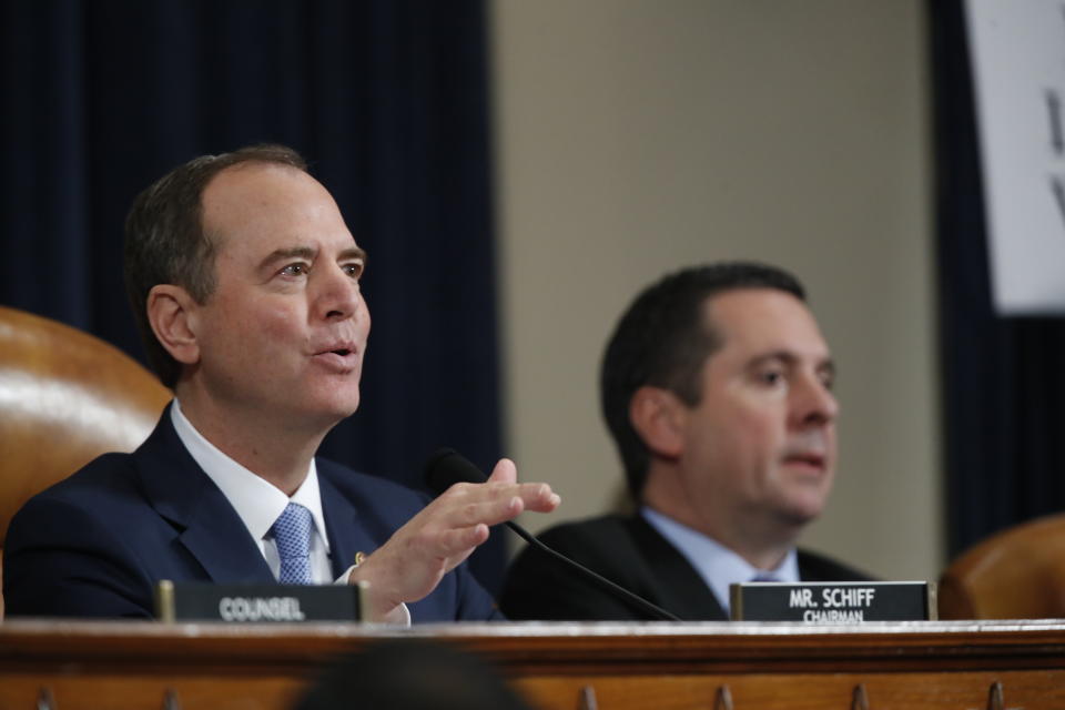 House Intelligence Committee Chairman Adam Schiff, D-Calif., questions former White House national security aide Fiona Hill, and David Holmes, a U.S. diplomat in Ukraine, testify before the House Intelligence Committee on Capitol Hill in Washington, Thursday, Nov. 21, 2019, during a public impeachment hearing of President Donald Trump's efforts to tie U.S. aid for Ukraine to investigations of his political opponents, as Rep. Devin Nunes, R-Calif, the ranking member of the House Intelligence Committee, looks on. (AP Photo/Alex Brandon)