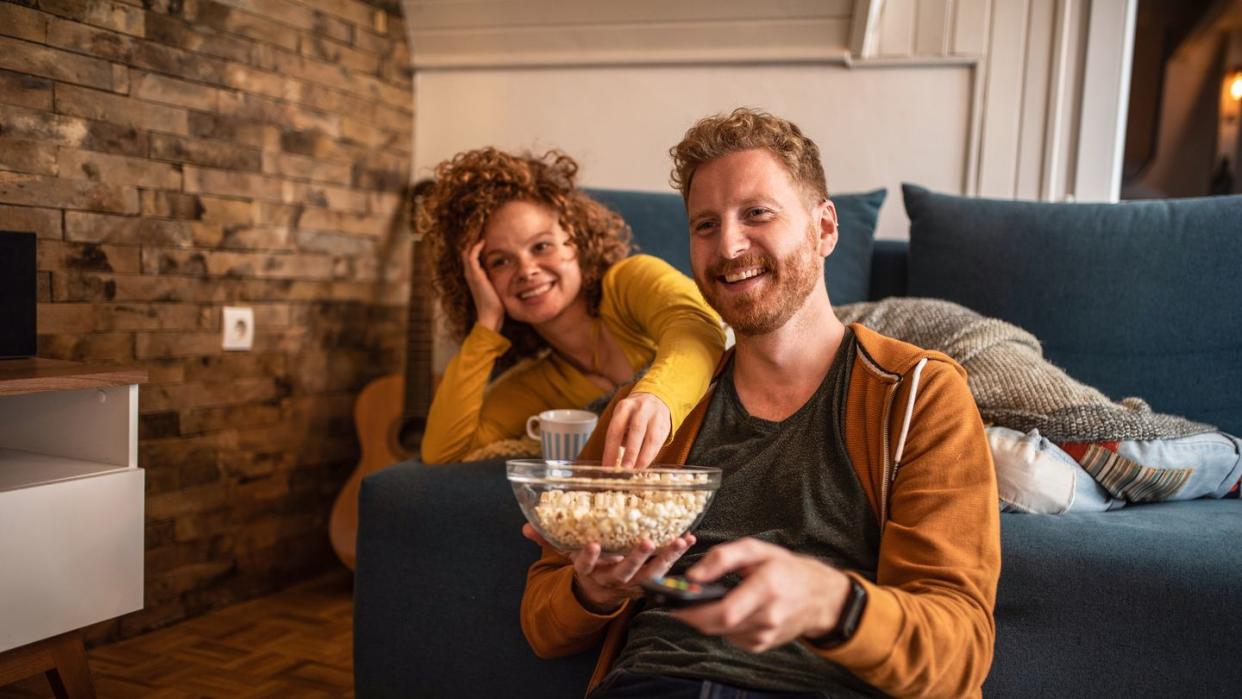 young couple watching a movie at home