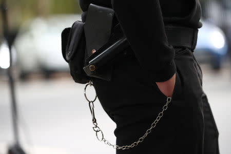 A prison officer stands outside Wormwood Scrubs Prison during a walk out protest in London, Britain, September 14, 2018. REUTERS/Hannah McKay