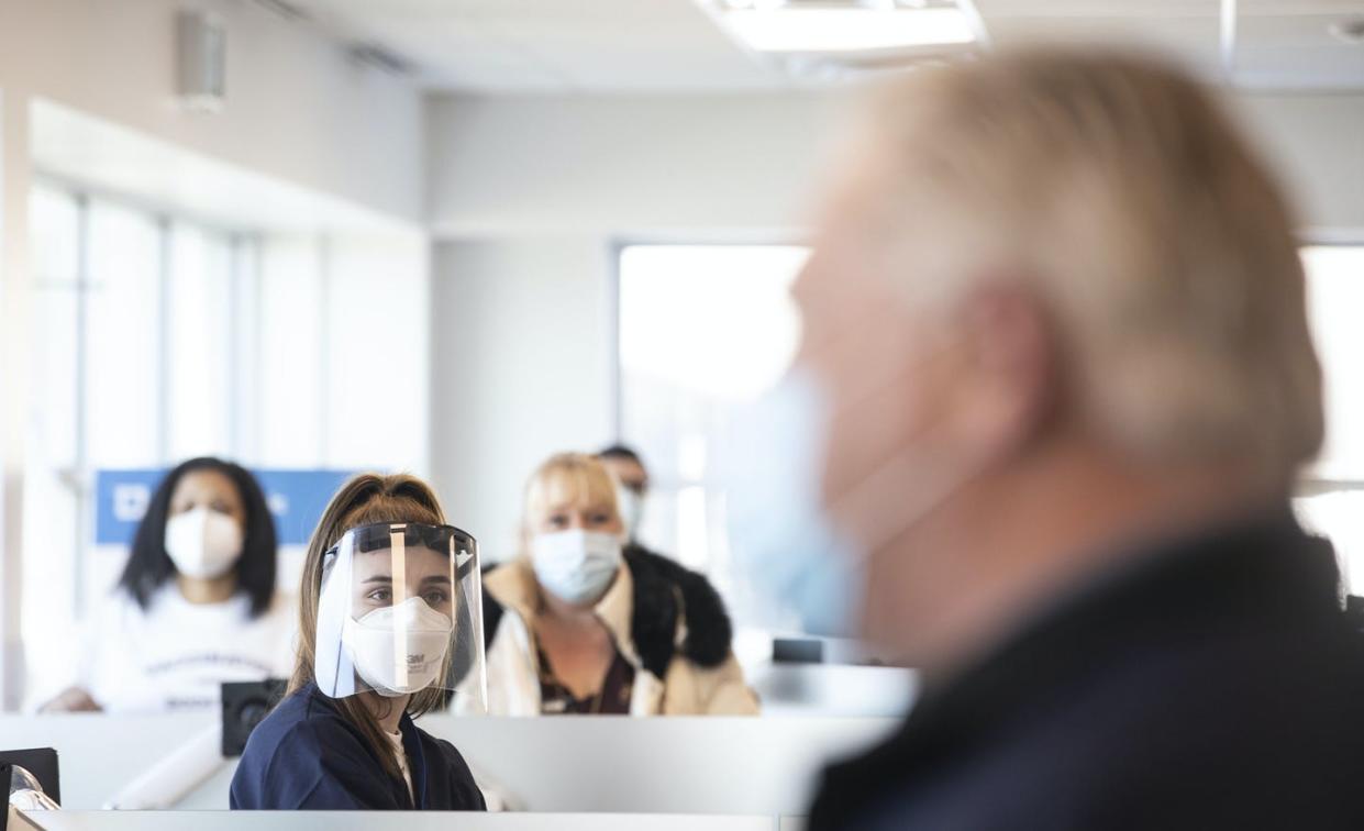 <span class="caption">A health-care worker and volunteers watch as Ontario Premier Doug Ford visits a vaccine clinic for Purolator employees and their families at the company's plant in Toronto.</span> <span class="attribution"><span class="source">THE CANADIAN PRESS/Chris Young </span></span>