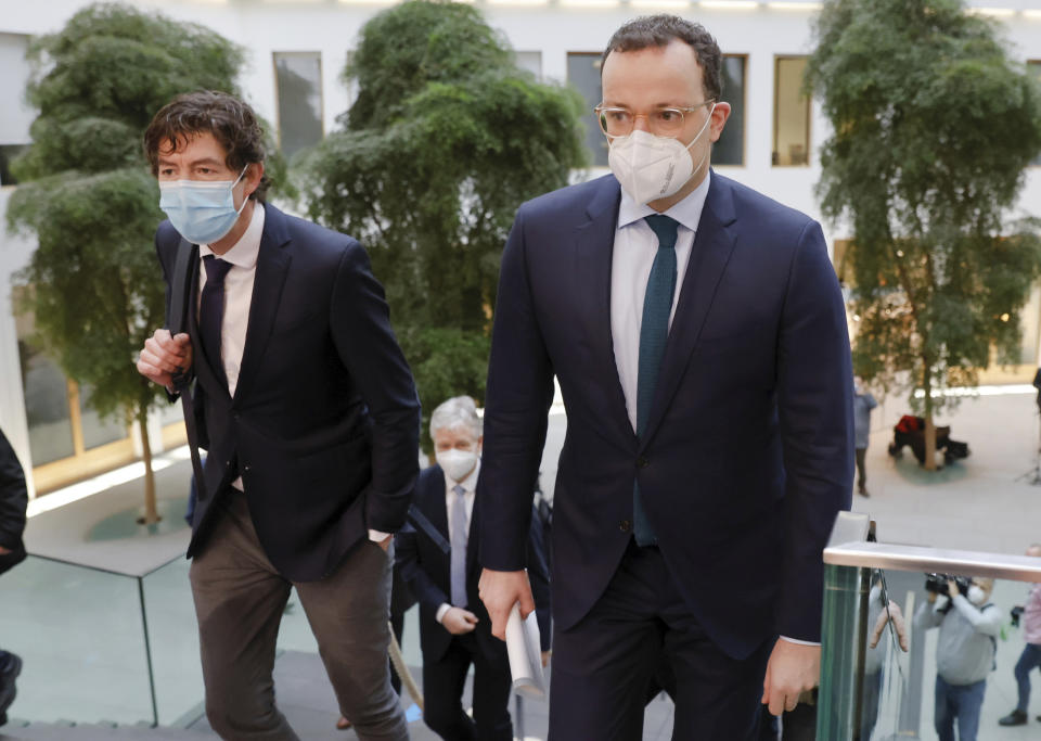 German Health Minister Jens Spahn and Director of the Institute for Virology at the Charite Christian Drosten arrive for a news conference, amid the spread of the coronavirus disease (COVID-19), in Berlin, Germany, Friday, Jan. 22, 2021. (Fabrizio Bensch/Pool via AP)