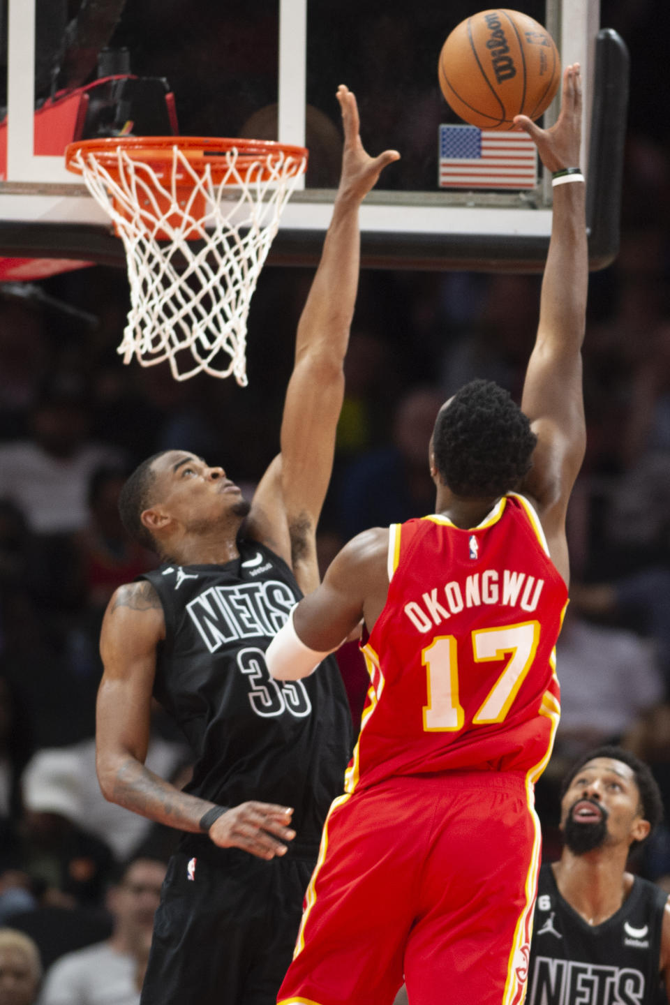 Atlanta Hawks forward Onyeka Okongwu (17) scores against Brooklyn Nets center Nic Claxton during the second half of an NBA basketball game, Sunday, Feb. 26, 2023, in Atlanta. (AP Photo/Hakim Wright Sr.)