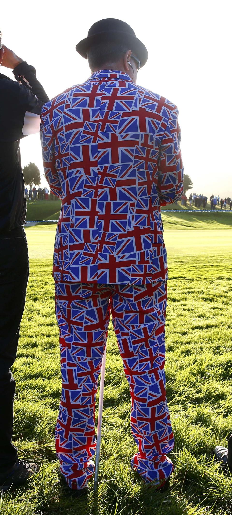 A spectator wears a bowler hat and Union flag suit as he watches 40th Ryder Cup at Gleneagles in Scotland September 26, 2014. REUTERS/Eddie Keogh (BRITAIN - Tags: SPORT GOLF)