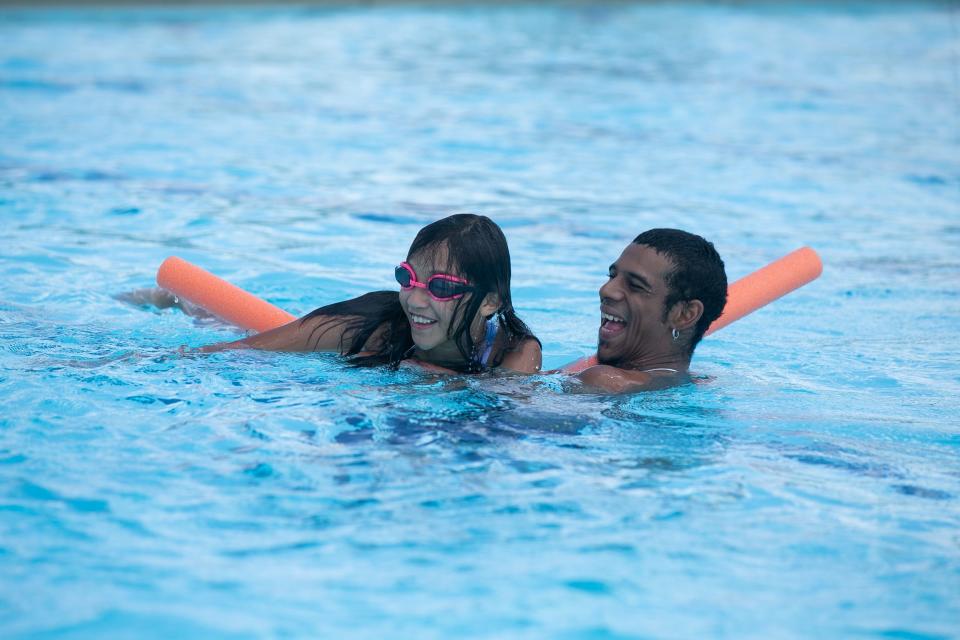 Jezzellenne Flores, 11, and Jay Jones laugh at their family members at Greenwood Pool Thursday, July 6, 2023.