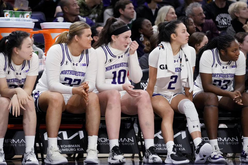 Northwestern players watch teammates during the second half of an NCAA college basketball game against Iowa in Evanston, Ill., Wednesday, Jan. 31, 2024. Iowa won 110-74. (AP Photo/Nam Y. Huh)