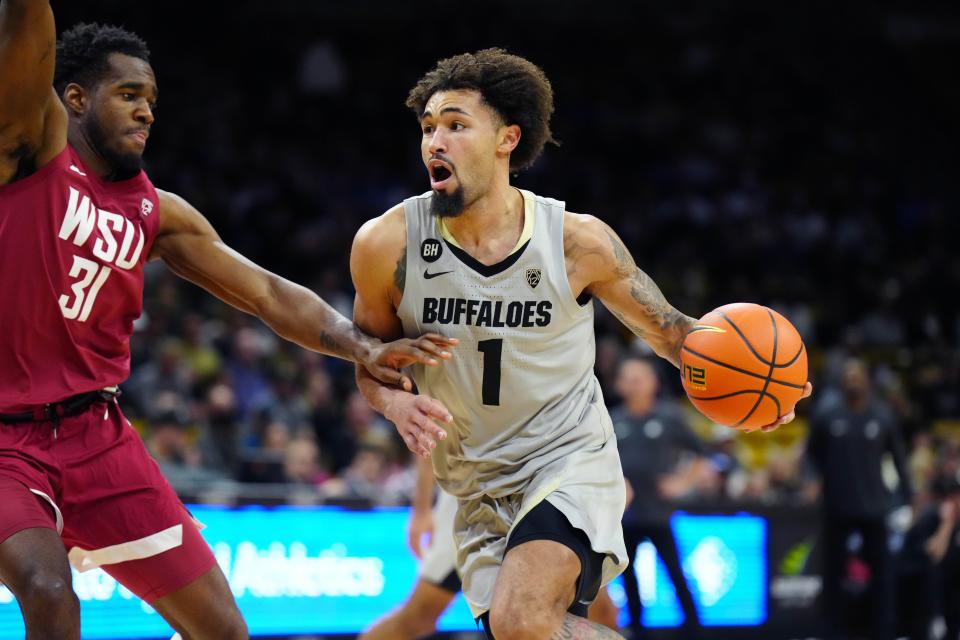 Dec 31, 2023; Boulder, Colorado, USA; Colorado Buffaloes guard J'Vonne Hadley (1) drives against Washington State Cougars guard Kymany Houinsou (31) in the second half at the CU Events Center. Mandatory Credit: Ron Chenoy-USA TODAY Sports