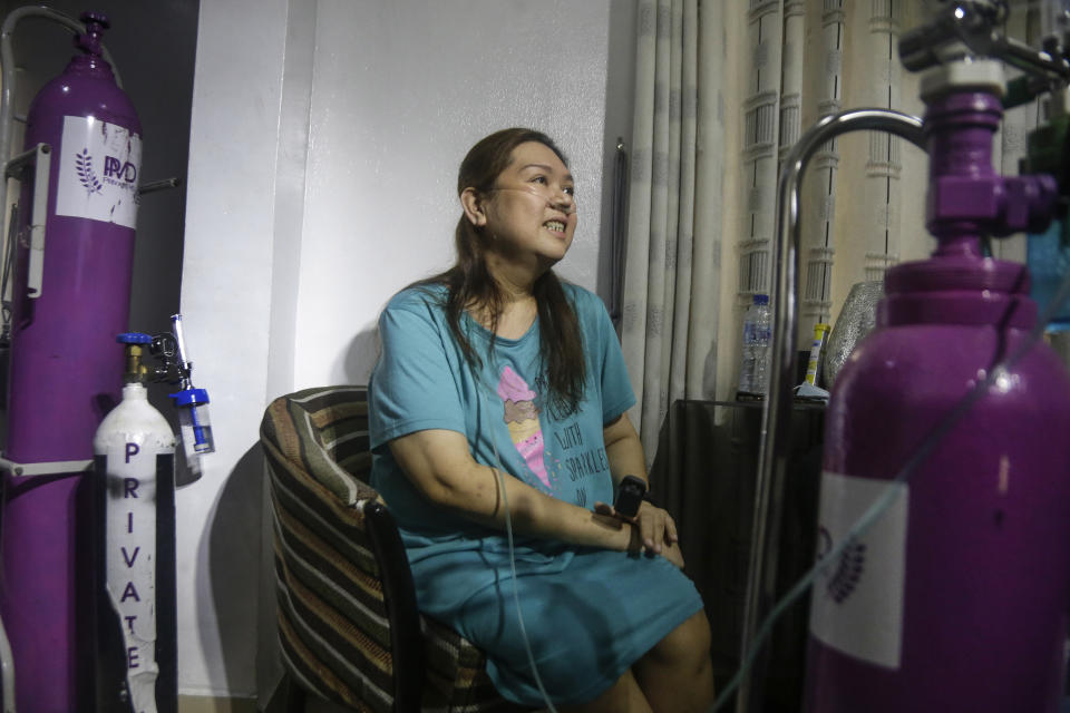 Maricar Tajo, 46, who is from the Philippines but moved to Nigeria in 2007 for work, receives oxygen from a private medical service at her house as she recovers from COVID-19 in Lagos, Nigeria Saturday, Feb. 6, 2021. She was resuscitated after falling unconscious in a hospital intensive care unit when her oxygen saturation levels dropped. (AP Photo/Sunday Alamba)