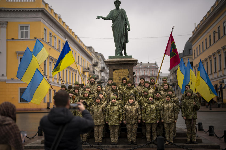 Ukrainian Army soldiers pose for a photo as they gather to celebrate a Day of Unity in Odessa, Ukraine, Wednesday, Feb. 16, 2022. As Western officials warned a Russian invasion could happen as early as today, the Ukrainian President Zelenskyy called for a Day of Unity, with Ukrainians encouraged to raise Ukrainian flags across the country. (AP Photo/Emilio Morenatti)