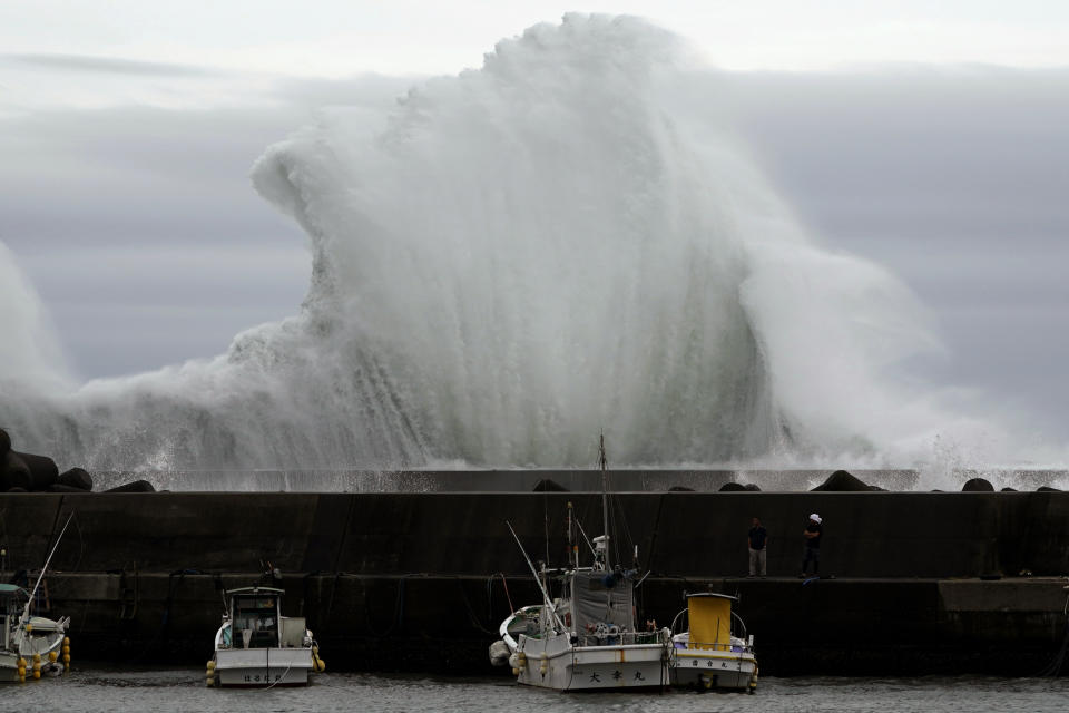 Surging waves hit against the breakwater behind fishing boats as Typhoon Hagibis approaches at a port in town of Kiho, Mie Prefecture, Japan Friday, Oct. 11, 2019. (AP Photo/Toru Hanai)