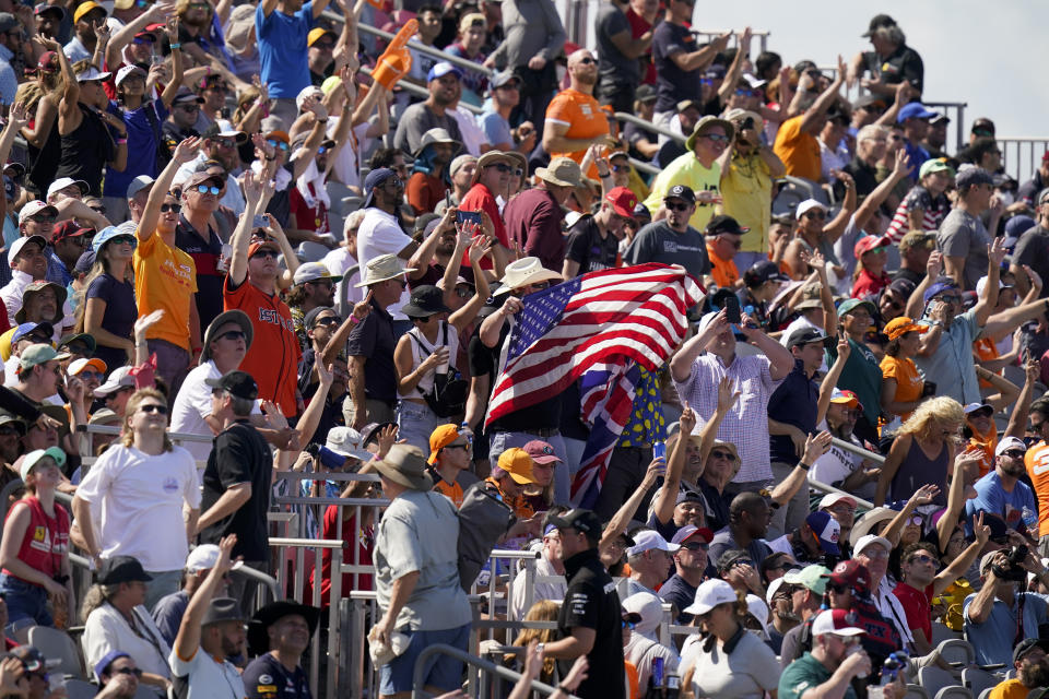 Spectators cheer at the start of the Formula One U.S. Grand Prix auto race at the Circuit of the Americas, Sunday, Oct. 24, 2021, in Austin, Texas. (AP Photo/Eric Gay)