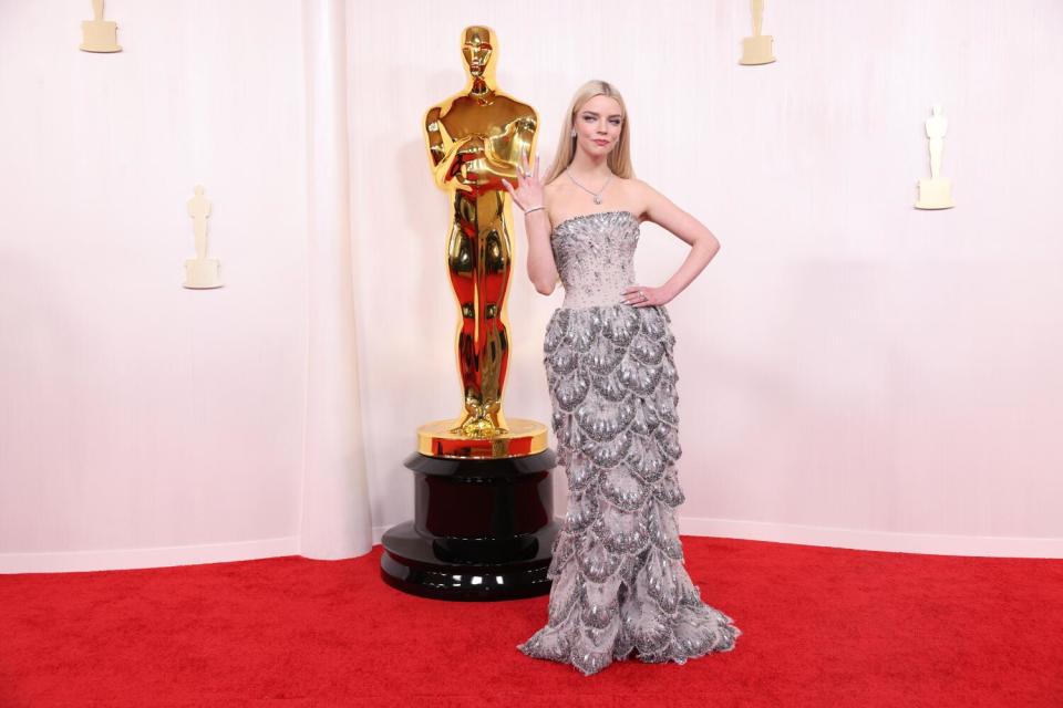 Anya Taylor-Joy wears a strapless silver dress with scalloped layers.