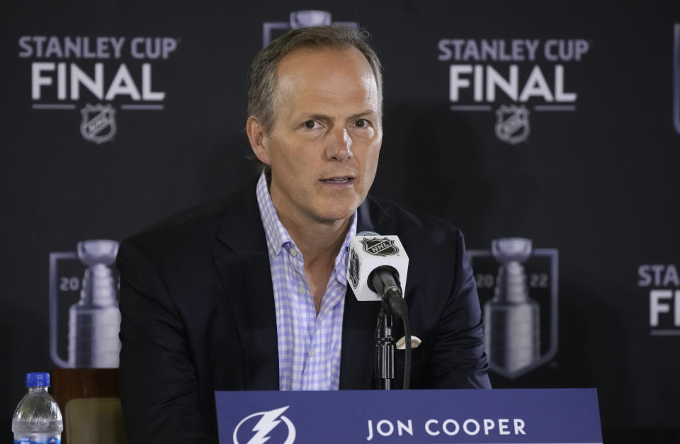 FILE - Tampa Bay Lightning head coach Jon Cooper speaks during an NHL hockey media day before Game 1 of the Stanley Cup Finals Tuesday, June 14, 2022, in Denver. Three months after falling short in a bid to become the first club in 40 years to win three straight Stanley Cup titles, the Lightning entered training eager to begin the quest to reclaim the crown they relinquished to the Colorado Avalanche last season.(AP Photo/David Zalubowski, File)