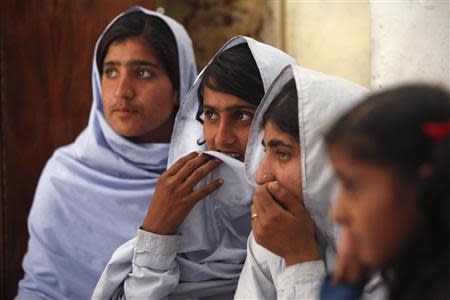 Students react while attending a lecture on preventive measures to take when sexual harassment occurs, during a class in Shadabad Girls Elementary School in Pir Mashaikh village in Johi, some 325 km (202 miles) from Karachi February 12, 2014. REUTERS/Akhtar Soomro