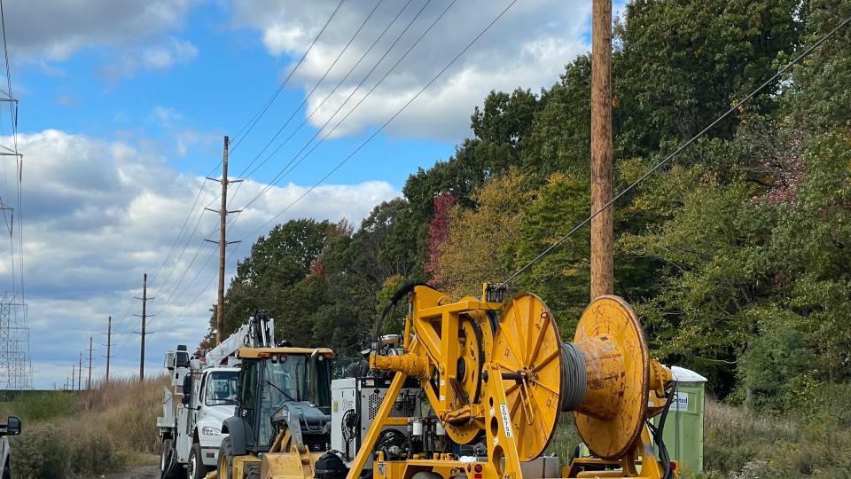 Line workers with Jersey Central Power & Light upgrade transmission lines  crossing Route 18 in Colts Neck.