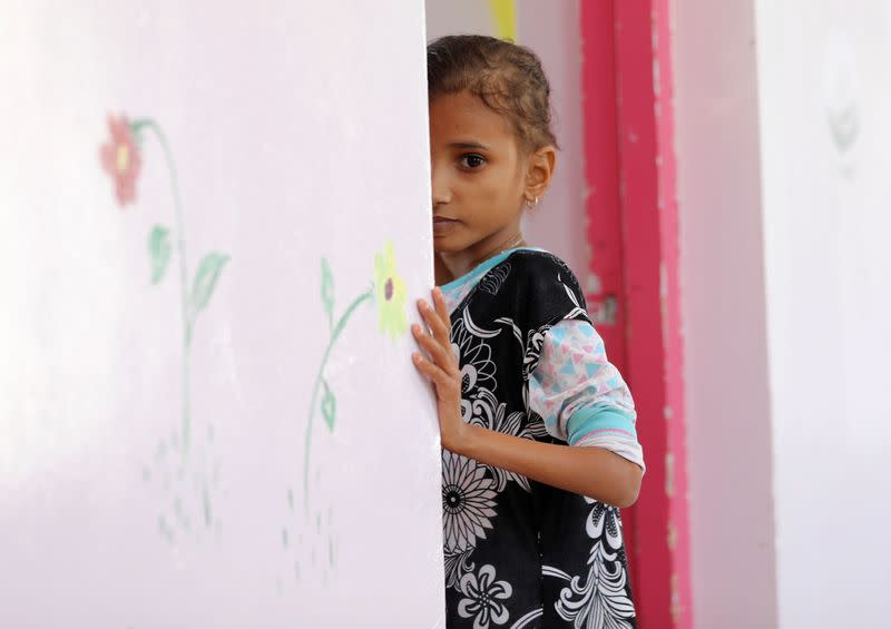 Ahmadiya Juaidi, 13, looks on as she stands at the door of her room at malnutrition treatment ward of al-Sabeen hospital in Sanaa