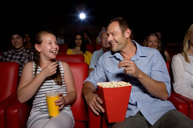 Father and daughter enjoying a movie