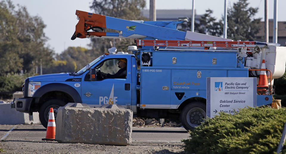 FILE - In this Feb. 11, 2020, file photo, a Pacific Gas & Electric truck leaves the company's Oakland Service Center in Oakland, Calif. PG&E's chief financial officer, Jason Wells, is expected to face questions Thursday, May 28 about the company's plan to nearly double its debt to almost $40 billion to finance its payments to wildfire victims, insurers and government agencies in the second day of the company's bankruptcy trial. Meanwhile, the Public Utilities Commission will vote on the bankruptcy plan. (AP Photo/Ben Margot, File)