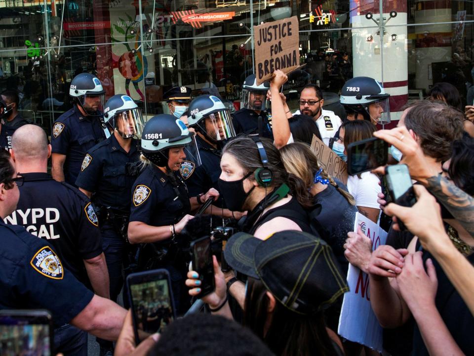 FILE PHOTO: Demonstrators scuffle with NYPD police officers as they try to march trough Times Square during a protest against racial inequality in the aftermath of the death in Minneapolis police custody of George Floyd, in New York City, New York, U.S. June 14, 2020. REUTERS/Eduardo Munoz
