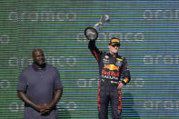 Red Bull driver Max Verstappen, right, of the Netherlands, holds up the winner's trophy as Shaquille O'Neal looks on at the Formula One U.S. Grand Prix auto race at Circuit of the Americas, Sunday, Oct. 24, 2021, in Austin, Texas. (AP Photo/Nick Didlick)