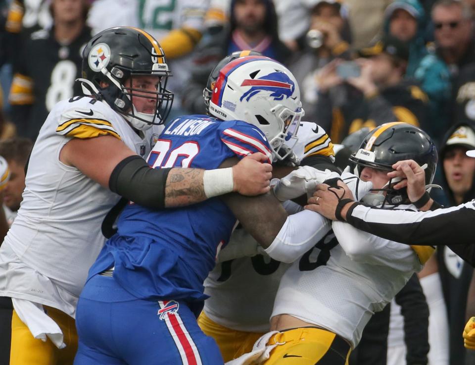 Bills defensive end Shaq Lawson (90) and Pittsburgh quarterback Kenny Pickett grab each others face masks in a late fourth quarter scrum during their game Sunday, Oct. 9, 2022 at Highmark Stadium in Orchard Park. 