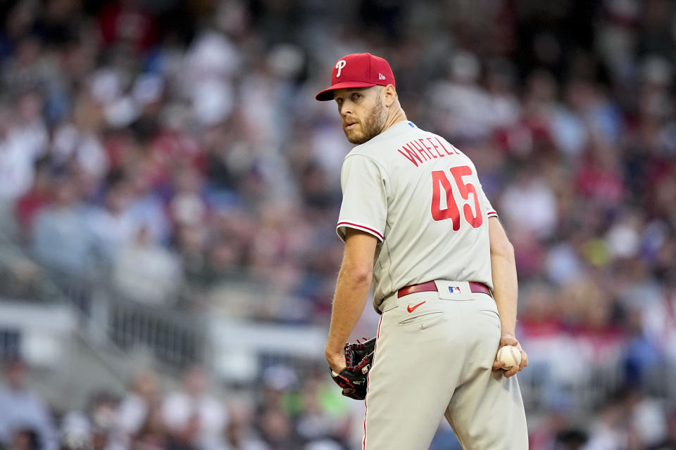 Philadelphia Phillies starting pitcher Zack Wheeler (45) checks the runner at first base in the second inning of Game 2 of a baseball NL Division Series against the Atlanta Braves, Monday, Oct. 9, 2023, in Atlanta. (AP Photo/Brynn Anderson)