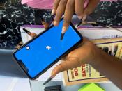 Lagos based entreprenuer Ogechi Egemonu opens the Twitter app on a smart phone at her office in Lagos