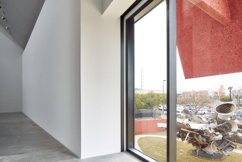 A concrete sun shade protects the interior and frames a view onto the exterior sculpture garden.