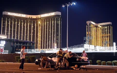 Las Vegas police stand guard along the streets outside the festival grounds of the Route 91 Harvest  - Credit: David Becker/Getty